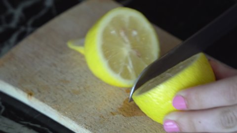Chef Hands Cutting Lemon In Kitchen
