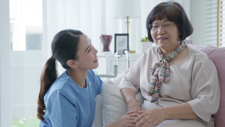 Young asian woman or nurse home smile looking at camera with senior grandmother give support empathy to elderly lady or older people in assisted living homecare mental health sick relief concept. Royalty-Free Stock Footage #1065375622