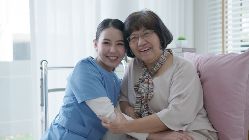 Young asian woman or nurse home smile looking at camera with senior grandmother give support empathy to elderly lady or older people in assisted living homecare mental health sick relief concept. | Shutterstock HD Video #1065375622