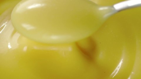 White Vanilla Bean Glaze Scooped And Dolloped With Spoon - Extreme Close Up Shot