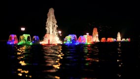 Fountains with color lights at night, slow motion video