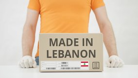 Box with MADE IN LEBANON text being placed on the table - Powered by Shutterstock - Get 15% off with code: PIKWIZARD15