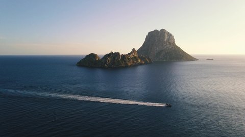 Aerial View of yacht near Ibiza, es Vedra and Vedranell islands. Drone footage of yachting in the Balearic islands. Very beautiful rocky islands