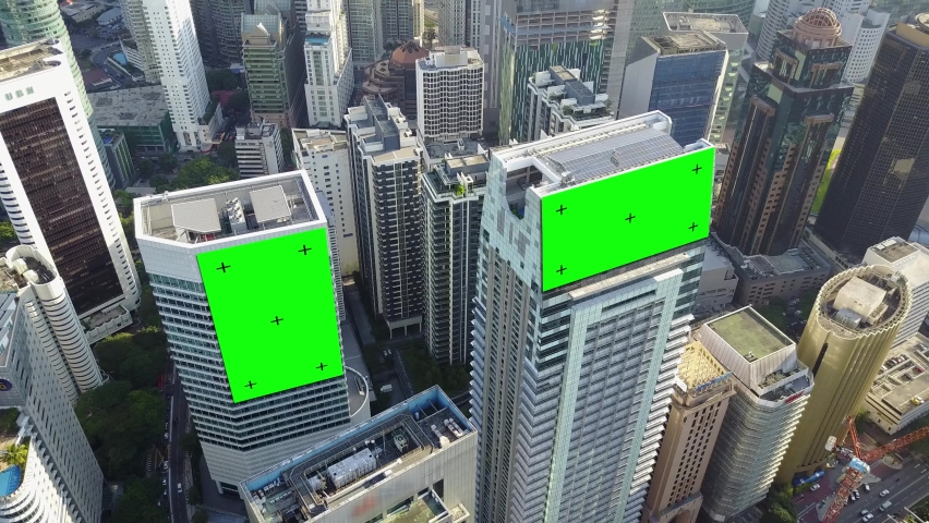 AERIAL. Top view of skyscrapers and green screen build board with tracking point. Bird view of modern city streets. Royalty-Free Stock Footage #1065386467