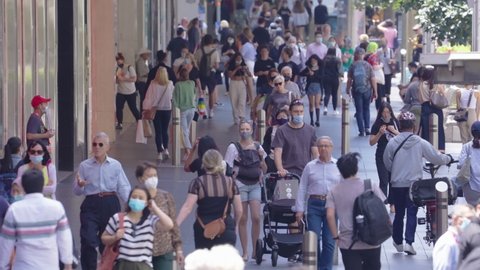 Melbourne, Australia - Jan 12, 2021: Slow motion video of pedestrians walking on the street in Melbourne, many are wearing face mask due to coronavirus pandemic
