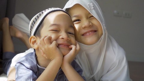 Slow motion portrait of Muslim Asian kids.Sibling in traditional Muslim dress.Cute smiling kids. 