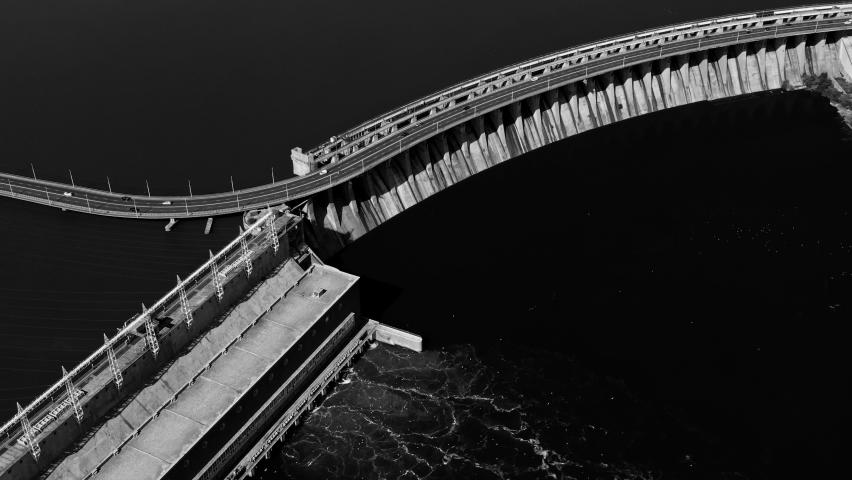Fly over the weir and power lines of water-power plant. Aerial establishing shot