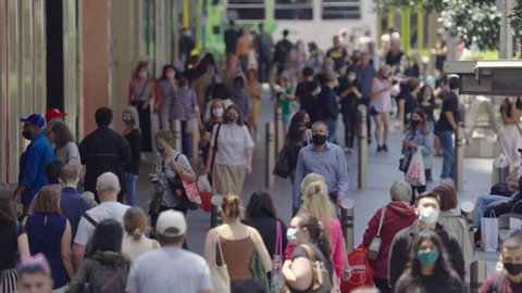 Melbourne, Australia - Jan 12, 2021: Pedestrians walking on the street in Melbourne, many are wearing face mask due to coronavirus pandemic