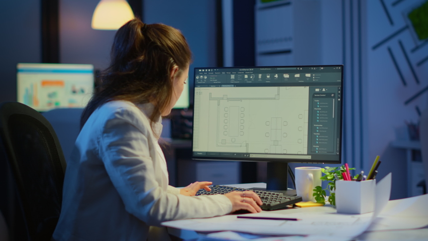 Woman architect matching digital plans from pc with blueprints working in startup business office overtime. Designer using cad software to design a 3D concept of buildings creating late at night | Shutterstock HD Video #1065410578