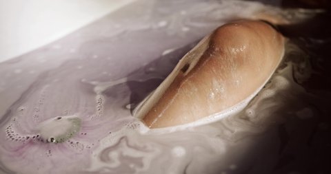 a woman knee soaked in a bathtub