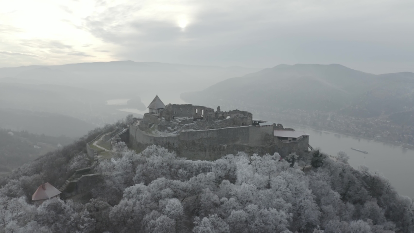 Aerial view of Castle Hill in Visegrad, Hungary. Tourist attraction in Europe. Beautiful winter daytime, sunset. RAW footage for creators to color grade (dlog, d log).