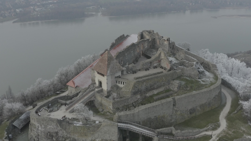 Aerial view of Castle Hill in Visegrad, Hungary. Tourist attraction in Europe. Beautiful winter daytime, sunset. RAW footage for creators to color grade (dlog, d log).