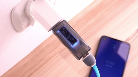 Voltage and Current Monitoring While Charging Smartphone from Wall Charger via USB Cable Closeup