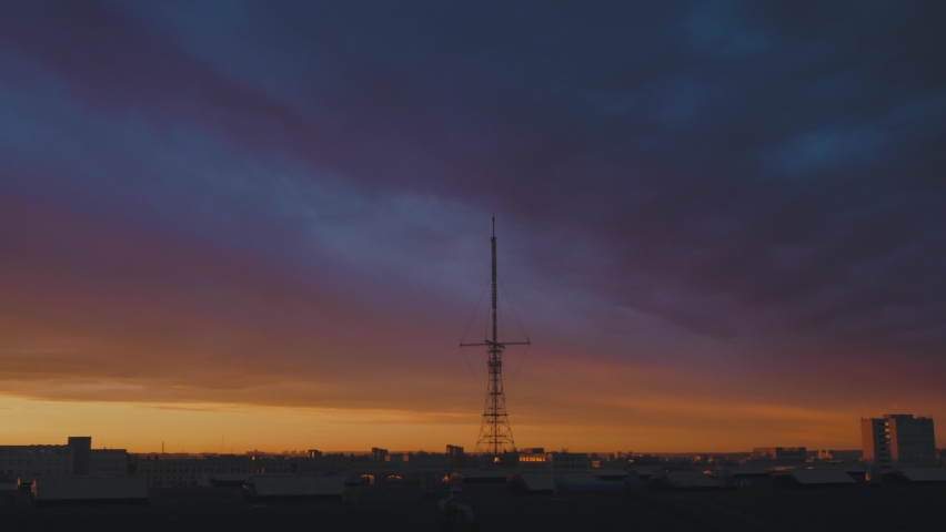 High TV tower. The day begins with morning broadcasts. Dawn over the city.