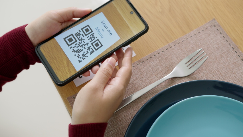 Hand's customer scan QR code for online menu service at table in restaurant during pandemic coronavirus. New normal contactless technology lifestyle protection coronavirus pandemic in restaurant - Powered by Shutterstock - Get 15% off with code: PIKWIZARD15
