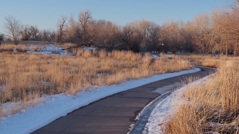 Fort Collins, CO, USA - January 11, 2021: Runners and bikers on biking trails along the Poudre River in Fort Collins in northern Colorado, winter scenery