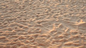 Beach sand texture Wavy sand on the beach with light of sunset or sunrise shadow on sand texture Evening time sun at sunset Video Zoom out