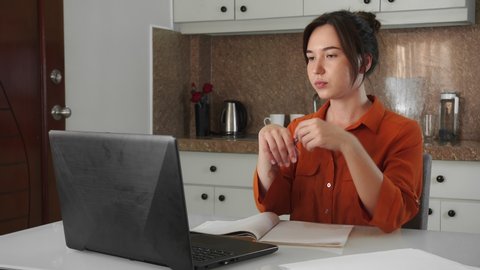 Young mixed race woman working with papers while sitting at home. Work or home education concept.