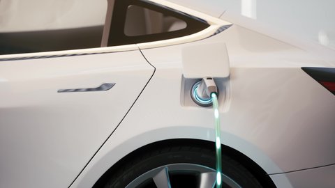 Electric car charging at a charging station. Charging cable is plugged into socket