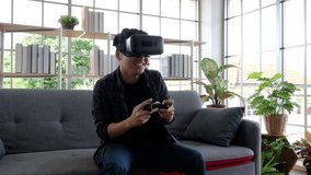 Attractive young man wearing virtual reality headset or 3d glasses sitting on sofa at home.