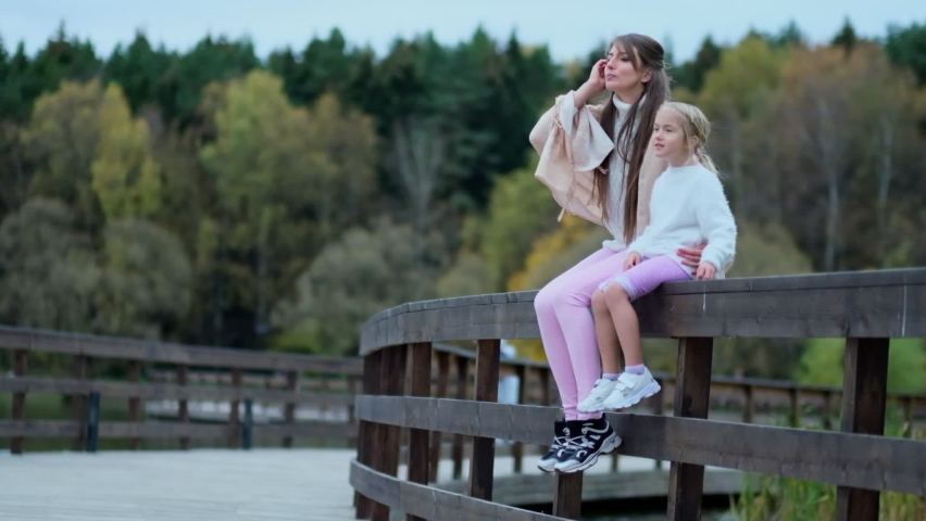 girl with her mom, mother with daughter spends time together. happy family spends time together in the park. relationships between generations. Slow motion video. stock footage