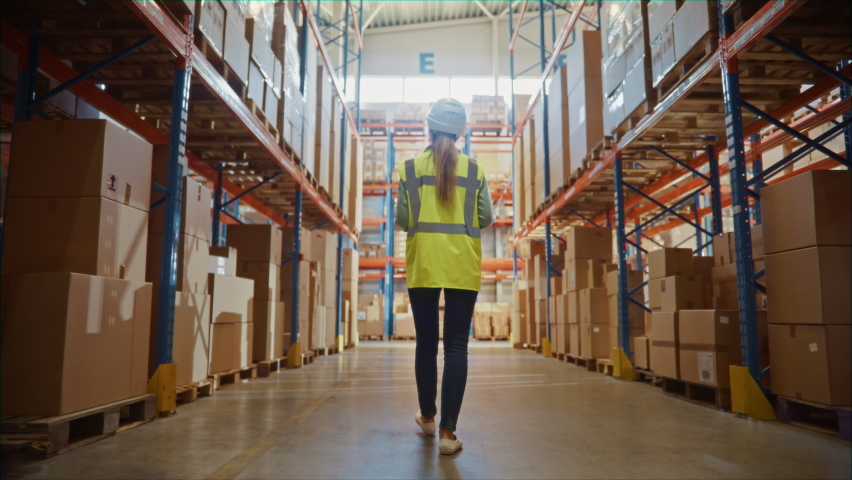 Futuristic Technology Retail Warehouse: Worker Doing Inventory Walks when Digitalization Process Analyzes Goods, Cardboard Boxes, Products with Delivery Infographics in Logistics, Distribution Center | Shutterstock HD Video #1065464998