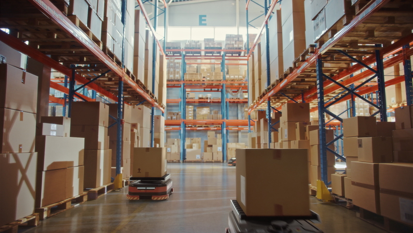 Future Technology 3D Concept: Automated Modern Retail Warehouse AGV Robots Transporting Cardboard Boxes in Distribution Logistics Center. Automated Guided Vehicles Delivering Goods, Products, Packages