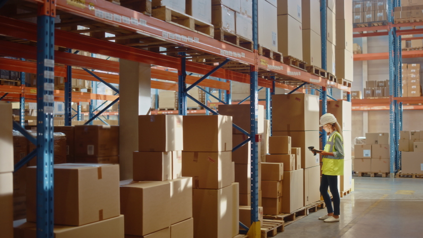 Futuristic Technology Retail Warehouse: Worker Starts Inventory Digitalization with Barcode Scanner Analyzes Goods, Cardboard Boxes, Products. Delivery Infographics in Logistics, Distribution Center Royalty-Free Stock Footage #1065465037