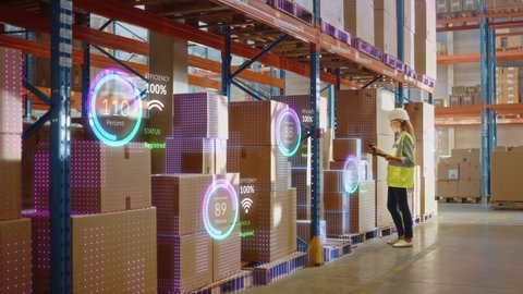 Futuristic Technology Retail Warehouse: Worker Starts Inventory Digitalization with Barcode Scanner Analyzes Goods, Cardboard Boxes, Products. Delivery Infographics in Logistics, Distribution Center