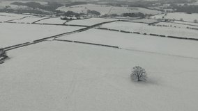 4K: Snowy landscape in Winter - Aerial Drone shot of fields and looking down to fields and hills. Stock Video Clip Footage