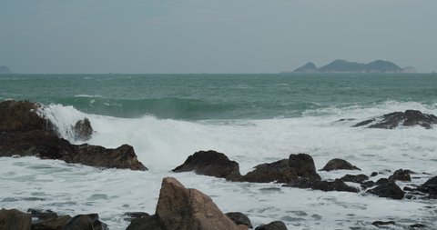 Sea crash over the rocky stone on beach
