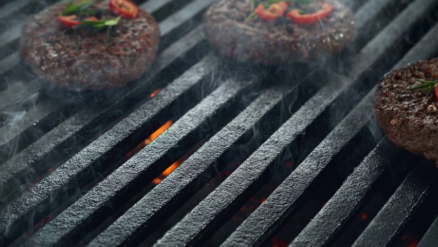 Barbecued Beef Burger Patty Falling onto Smoking and Flaming Grill Grate in 1000fps (Phantom Flex) Royalty-Free Stock Footage #1065468892