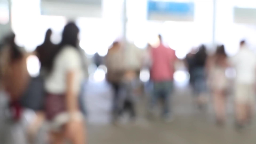 blurred crowd of people walking