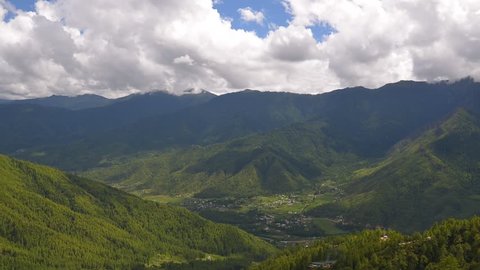 Paro valley with cloudy ,Bhutan.
Paro is the location of  only one international airport in Bhutan.
During moving cloud you can see  airplane prepare to landing.