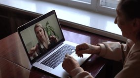 Senior woman make video call using laptop at home. COVID 19 Stay connected. Online chatting with assistants