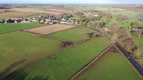 Aerial drone footage of the British country side fields in the winter time, taken in the town of Wetherby in Yorkshire in the UK showing a new house being built.