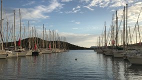 yachts side by side in luxury marina yacht masts stretched out to the sky great perspective panoramic views Sky Blue cloudy Sea Blue 4K video capture natural background footage