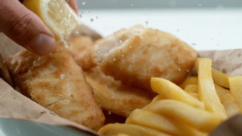 Fish and Chips with lemon in slow motion. Shot with Phantom Flex 4K camera.