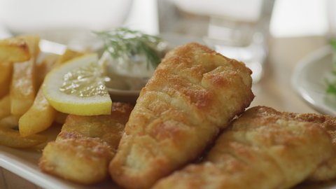 Fish and Chips on plate with garnish and lemon.