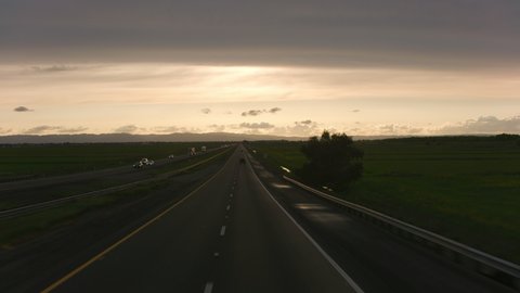 California circa-2020. Stabilized driving shot of road at sunset. Shot with Cineflex gimbal and RED 8K camera.