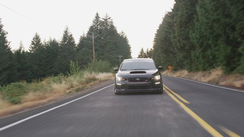 Oregon circa-2020: Subaru sports car driving on rural road