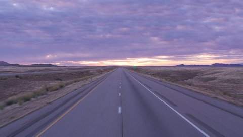 Utah circa-2020. Stabilized driving shot of road at sunrise. Shot with Cineflex gimbal and RED 8K camera.