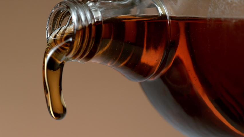 Bottle of maple syrup pouring in slow motion. Shot with Phantom Flex 4K camera. Royalty-Free Stock Footage #1065497698