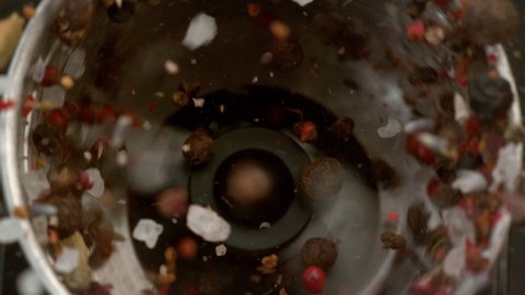 Close-up slow motion shot of pepper, salt and spices in grinder. Shot with Phantom Flex 4K camera.