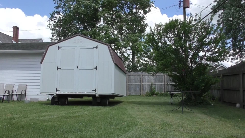 Wooden Shed being pulled into backyard