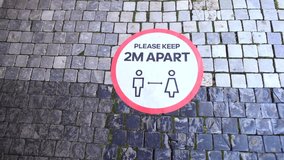 Precautionary sign for citizens on the pavement footway. Please keep 2m apart. Warning reminders in the city due to quarantine COVID-19 measures.  - Powered by Shutterstock - Get 15% off with code: PIKWIZARD15