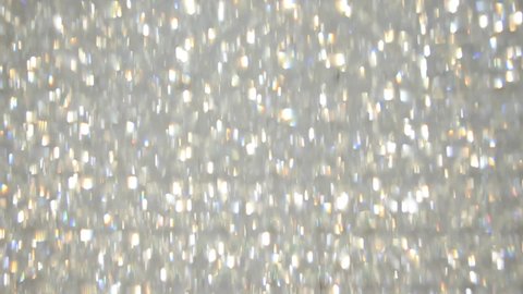 A texture in motion made from glitter in silver paint. Video background for video editing. Background. Shiny dots movement.
