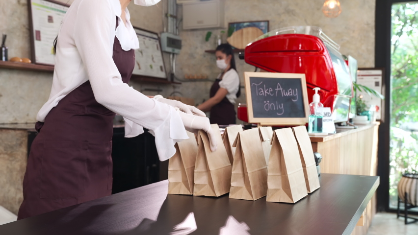 4K UHD Slow motion Close up dolly shot : Asian Waitress Preparing take away food while customer choose order from them. This is essential popular service after city lockdown from coronavirus pandemic. Royalty-Free Stock Footage #1065515482