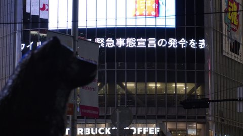 SHIBUYA, TOKYO, JAPAN - 7 JAN 2021 : Japan's Prime Minister Suga Yoshihide declared a state of emergency to stop the spread of the Coronavirus (COVID-19). Breaking news on screen at Shibuya crossing.