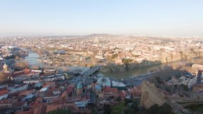 Beautiful fly from right to left 4k panoramic aerial video on Tbilisi city in winter sunny day, Georgia